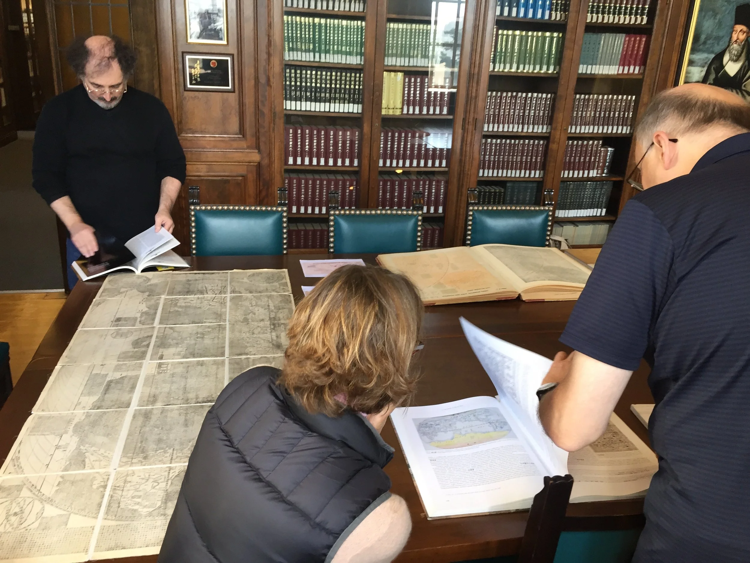 Hughen/Starkweather interview Mark Mir, archivist, and Antoni Ucerler, historian, at the Ricci Institute map library, as part of research for Shifting Shorelines