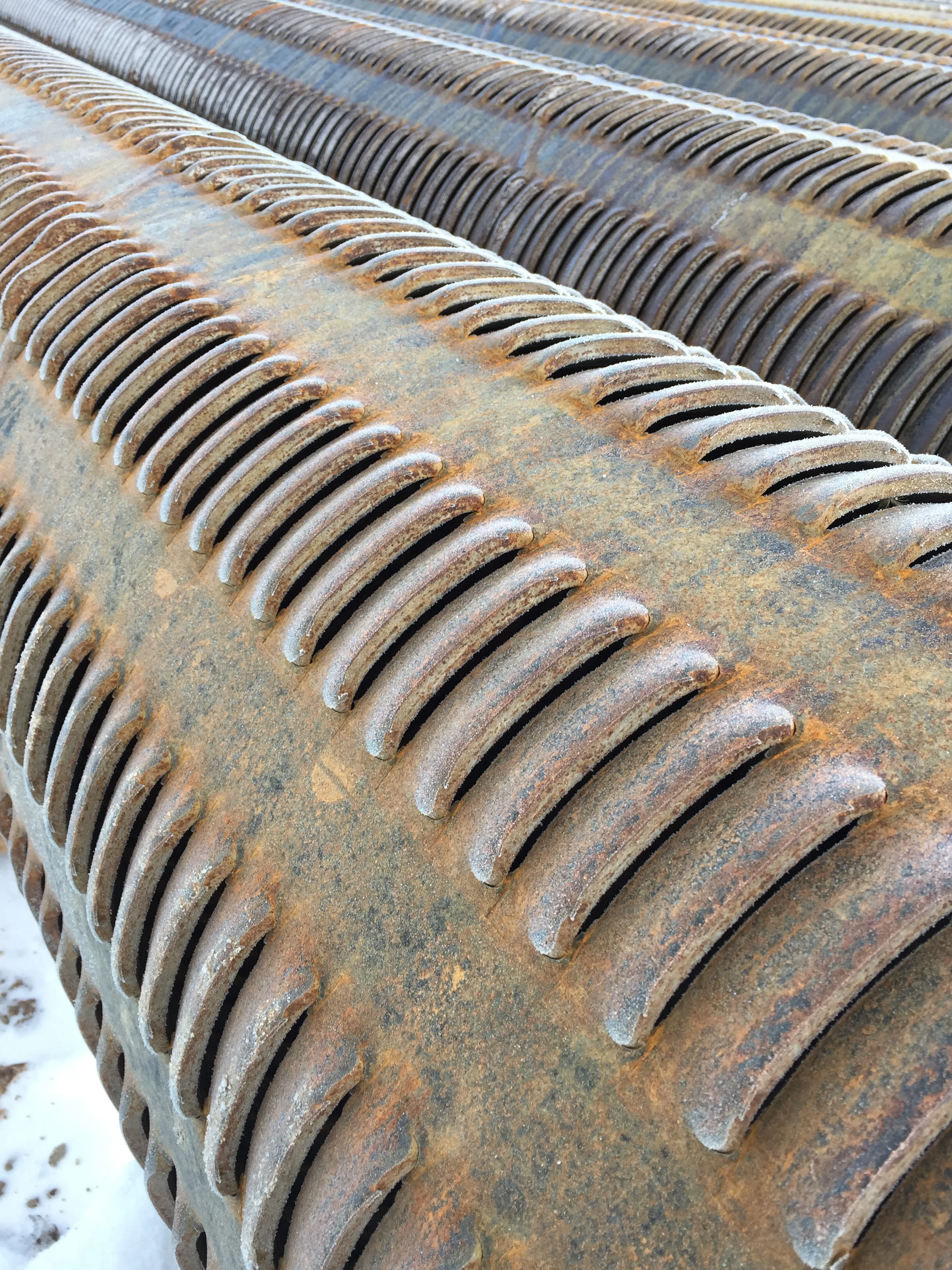 Louvered steel screen pipe is placed in the well in sections where water bearing strata are found.