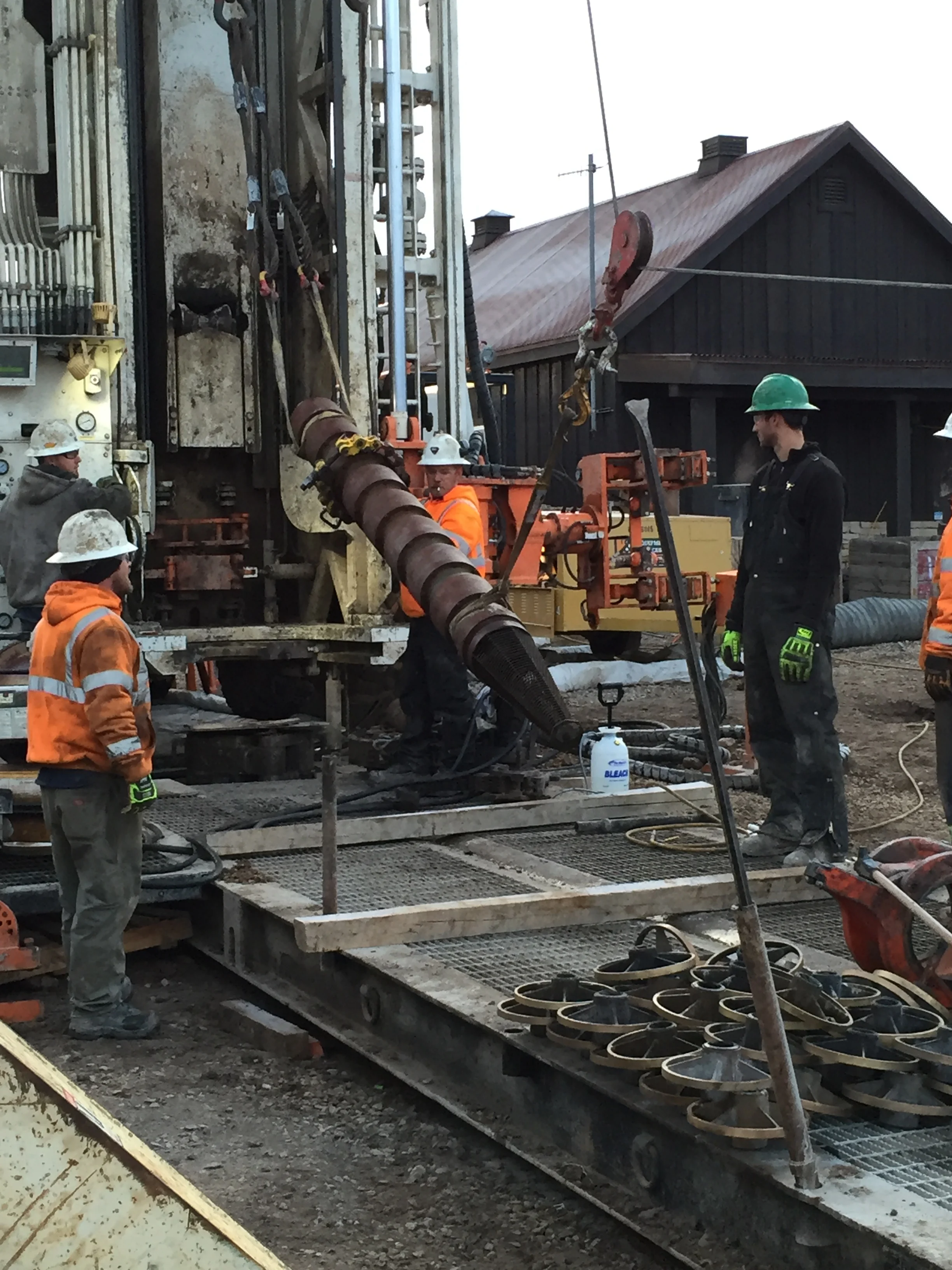 Insertion of water test pump into the well casing.