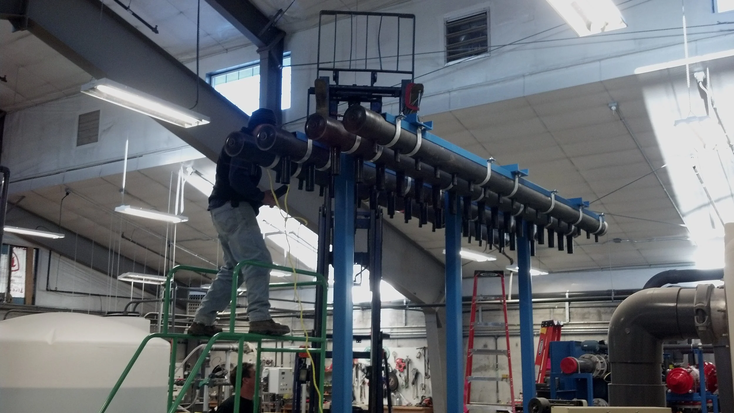Assembling the header of the new 1 MGD plant expansion skid.