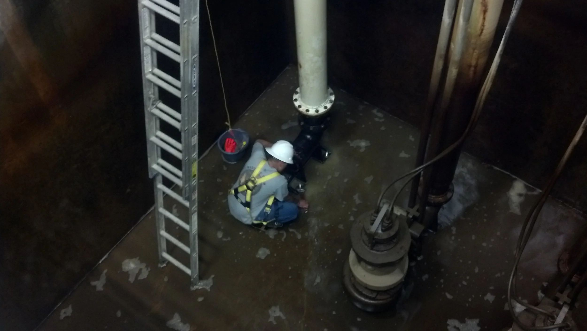 Installing a new feed pump in the plant intake wet-well, used to feed the new 1 MGD treatment skid expansion.