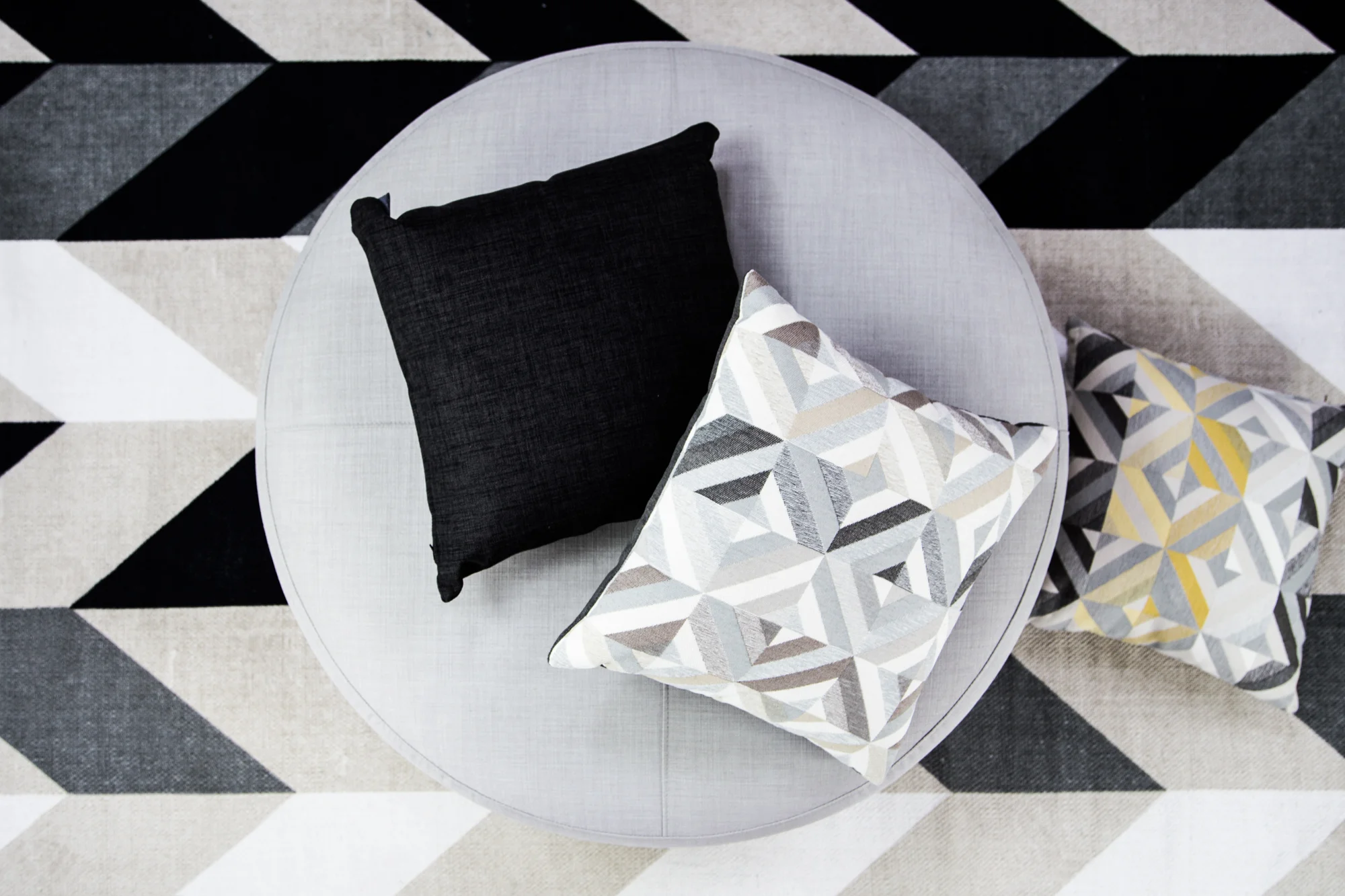 Ottoman: Lunar Soft Grey. Scatters (left to right): Lunar Graphite, Ecuador Nougat, Ecuador Citrus.