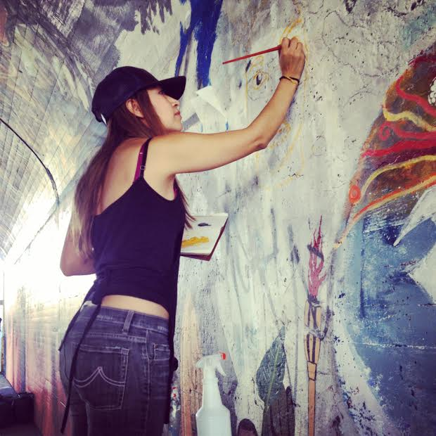 Painting part of a mural on Glendale Blvd in Echo Park, California
