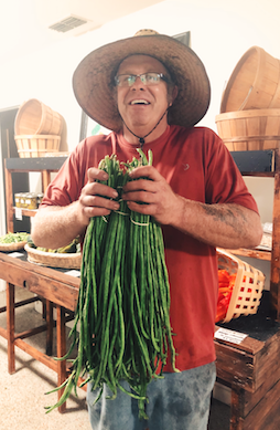 Jeff with his yard long beans in the farm store!