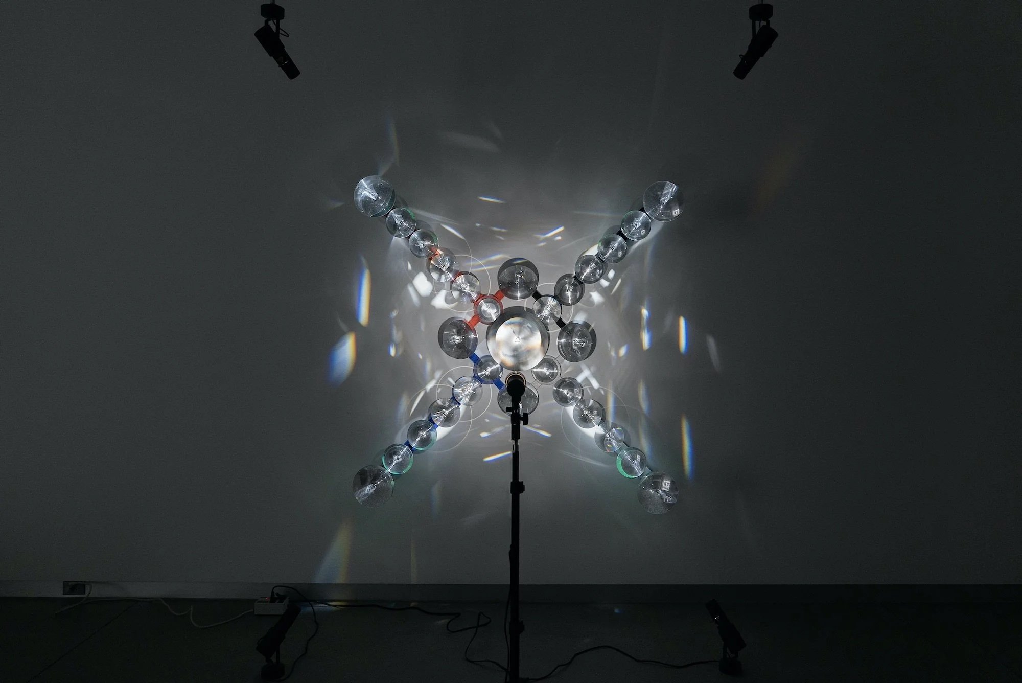   emplacement , 2023, light, mirrors, prisms, lenses, acrylic, ponderosa, 63x63x16.5in/160x160x42cm 
