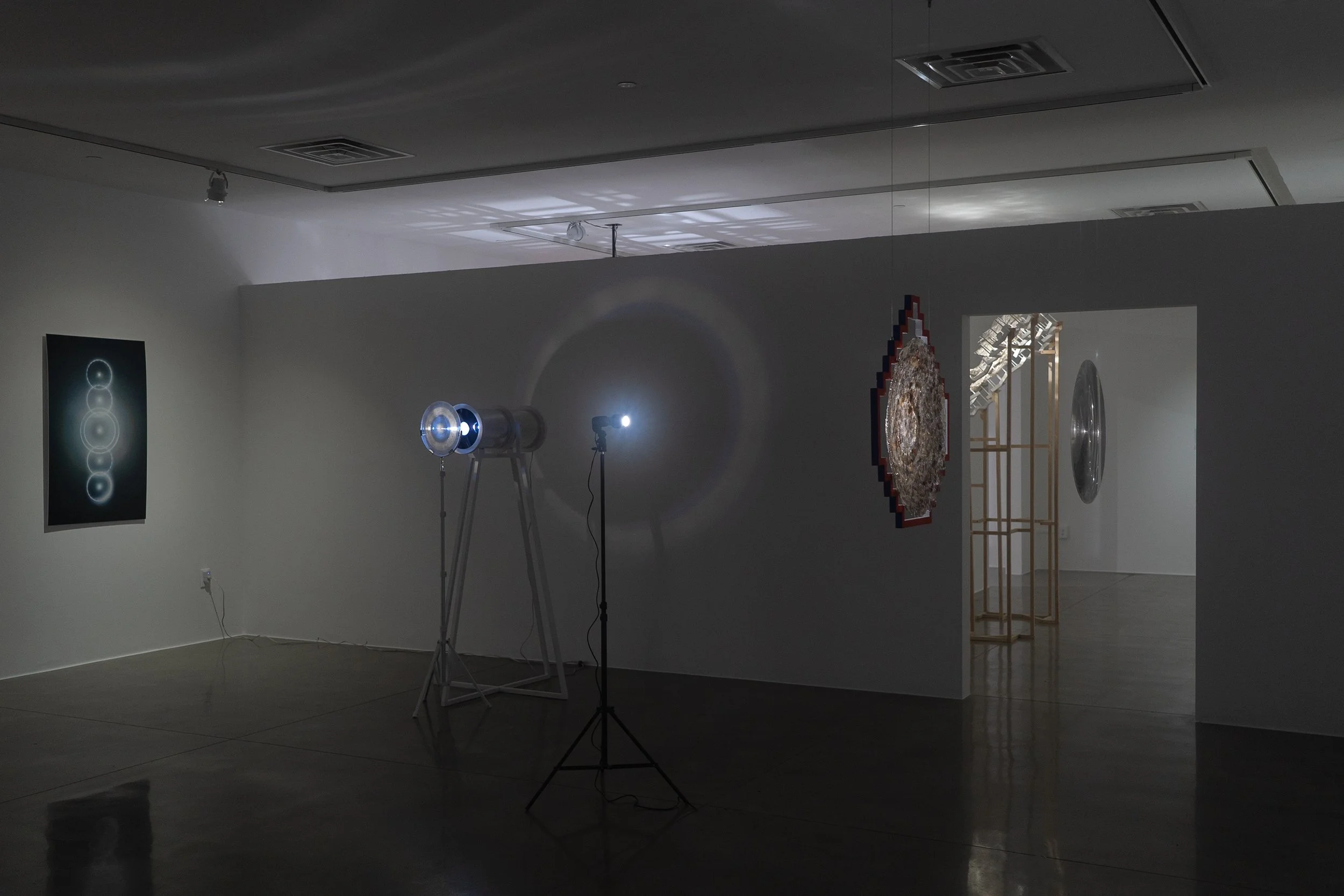  left to right:  nemontemi (cinco días intercalares) , 2026, photograph, 48×30in;  seeing environment , 2024, light, acrylic, aluminum, mylar, ponderosa, 65.5x38x25in (light source);  cosmovisión,  2026, light, mica, acrylic, ponderosa, 32.5x30.25x4.