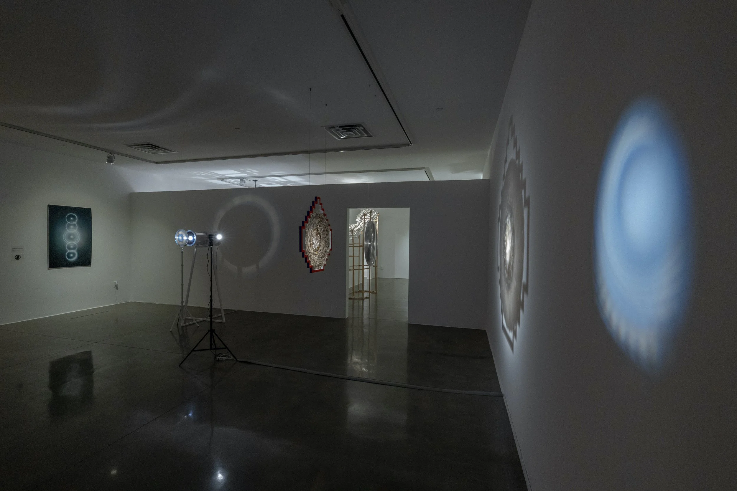  left to right:  nemontemi (cinco días intercalares) , 2026, photograph, 48×30in;  seeing environment , 2024, light, acrylic, aluminum, mylar, ponderosa, 65.5x38x25in (light source);  cosmovisión,  2026, light, mica, acrylic, ponderosa, 32.5x30.25x4.