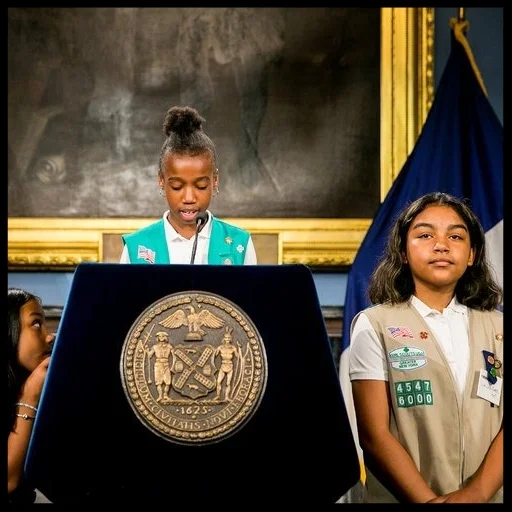Members of Troop 6000, a Girl Scouts group based in a homeless shelter in Long Island City, at a news conference announcing the expansion of the program to 14 other shelter sites. Credit: Sam Hodgson for The New York Times