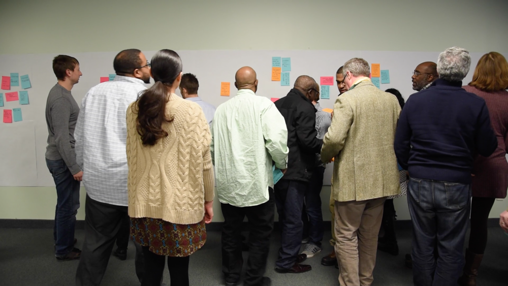 This group is using large, rectangular Post-It Notes to accomplish the same thing.