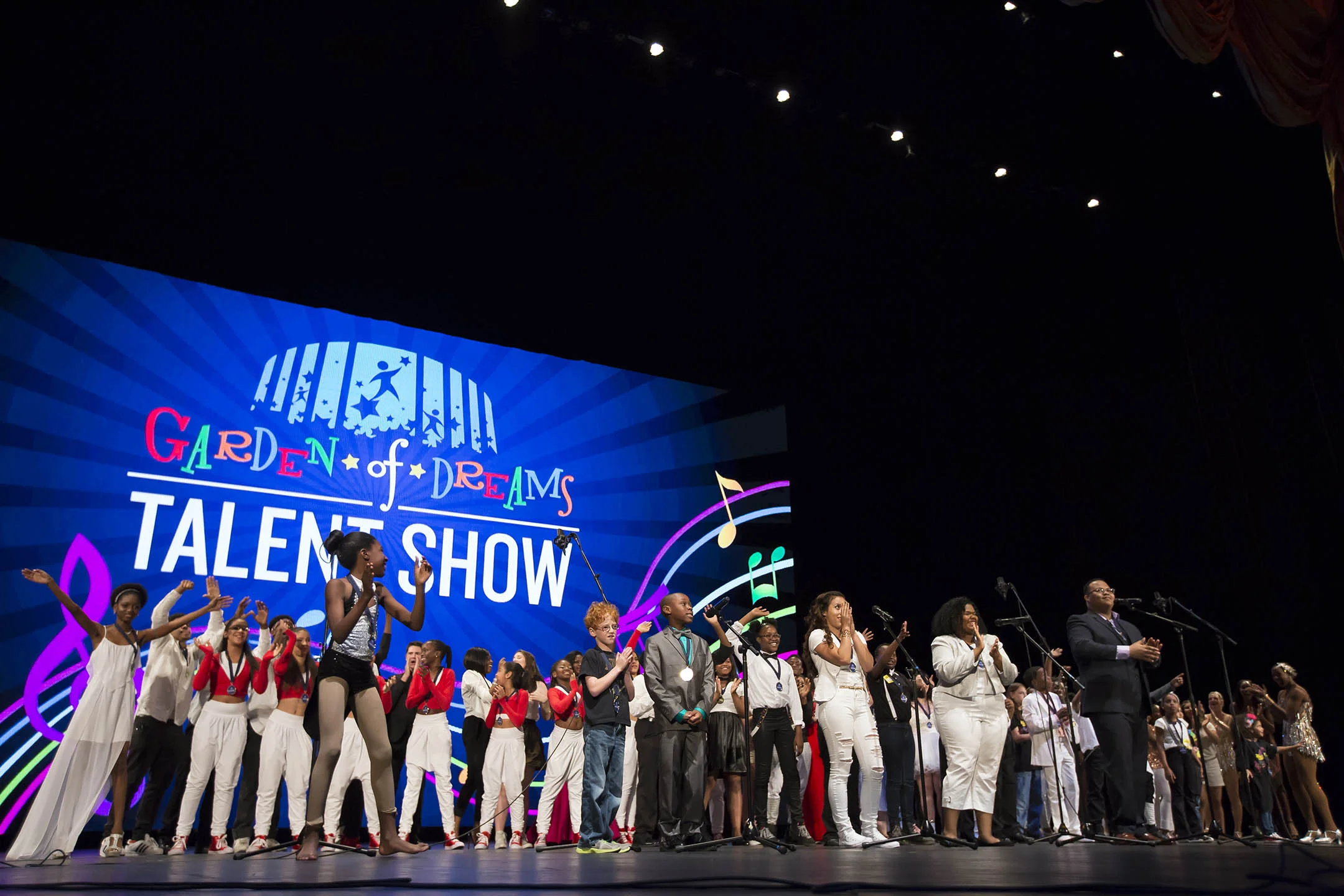 Children performing on stage at Radio City Music Hall as part of the 2015 Garden of Dreams Talent Show. My animation is running as the backdrop for every performance that evening.