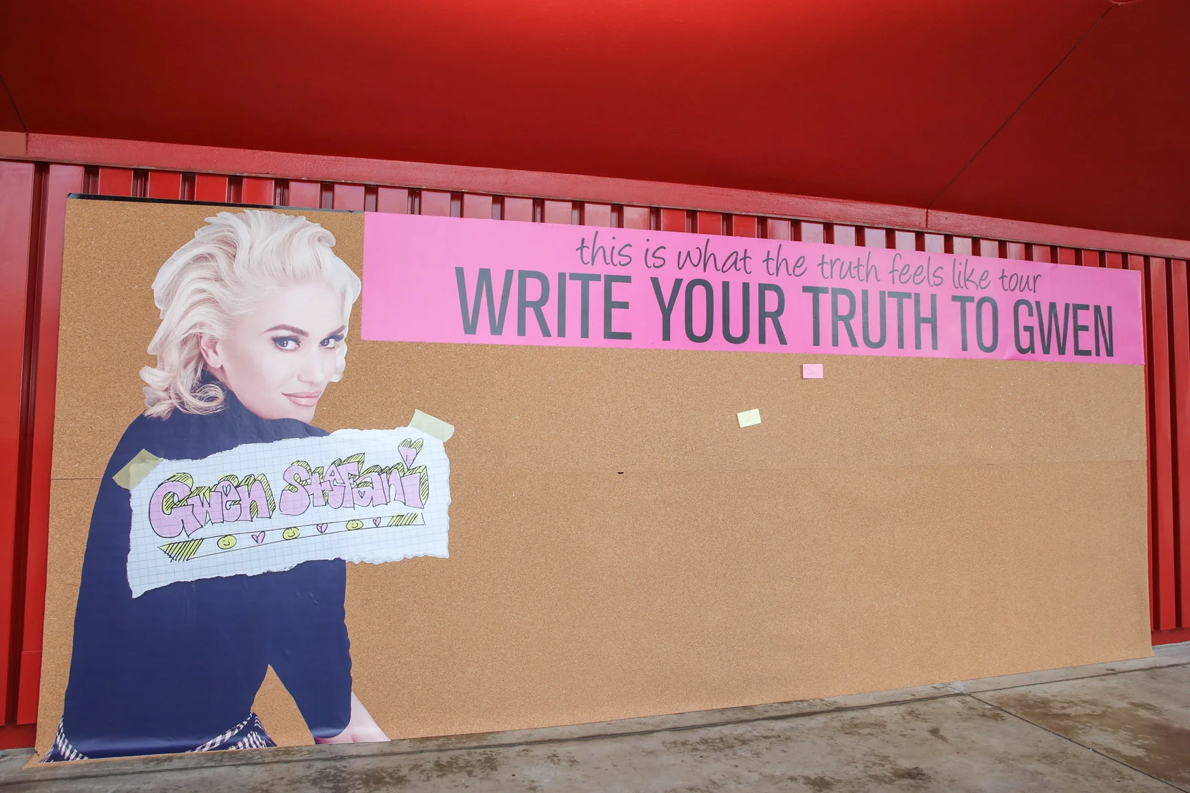 A 24' wide, 8' tall cork board with Gwen Stefani banner and decal that let fans attending her show at The Forum in CA to post their own truths for Gwen Stefani to read on sticky notes, which was a theme in her tour artwork.