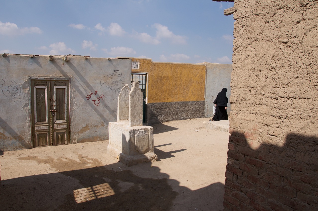 Woman walks inside the Southern Cemetery of al-Qarafa. Cairo. Egypt. 2016. © Michele Cortina