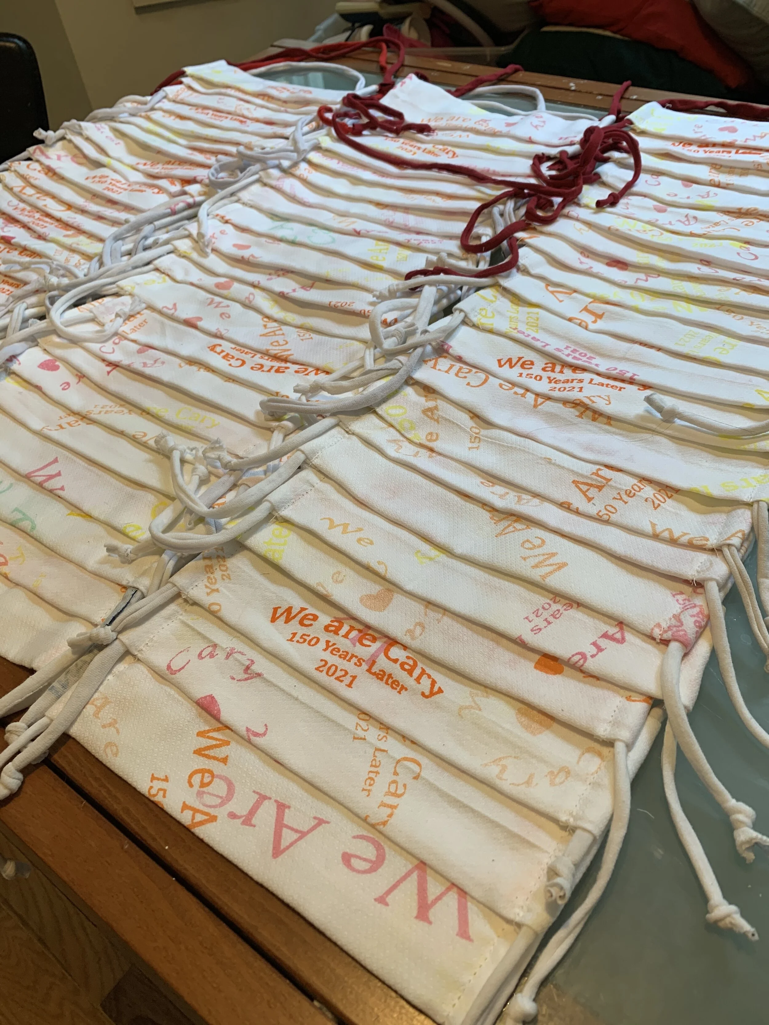 Stacks and rows of “We Are Cary” masks, ready to be bagged and distributed.