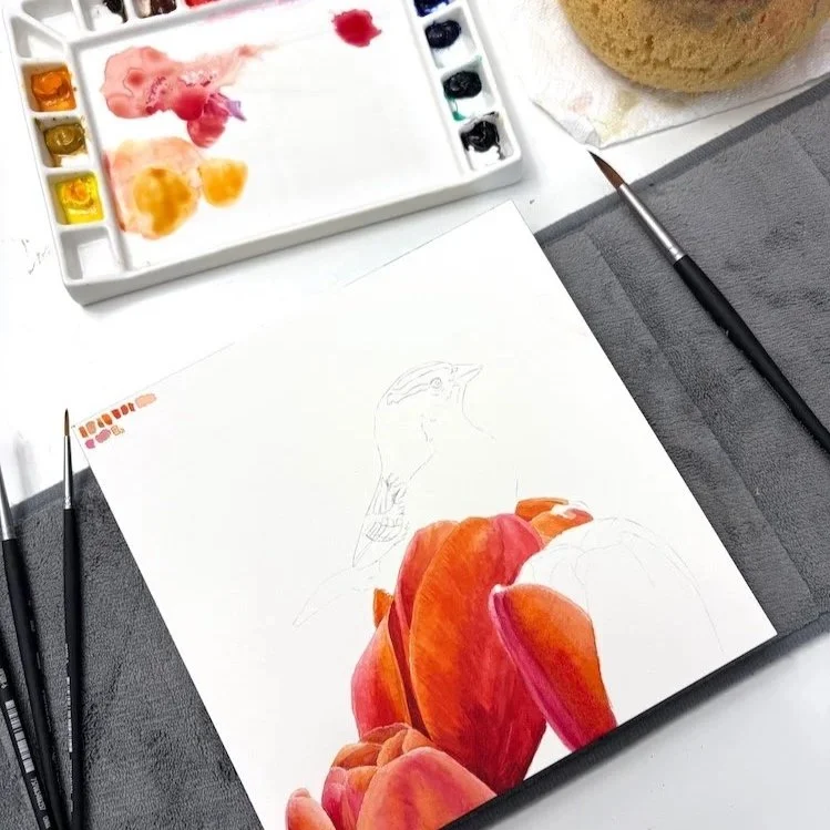 In progress photo of a watercolor painting where the tulips are complete, but the bird is not yet done.