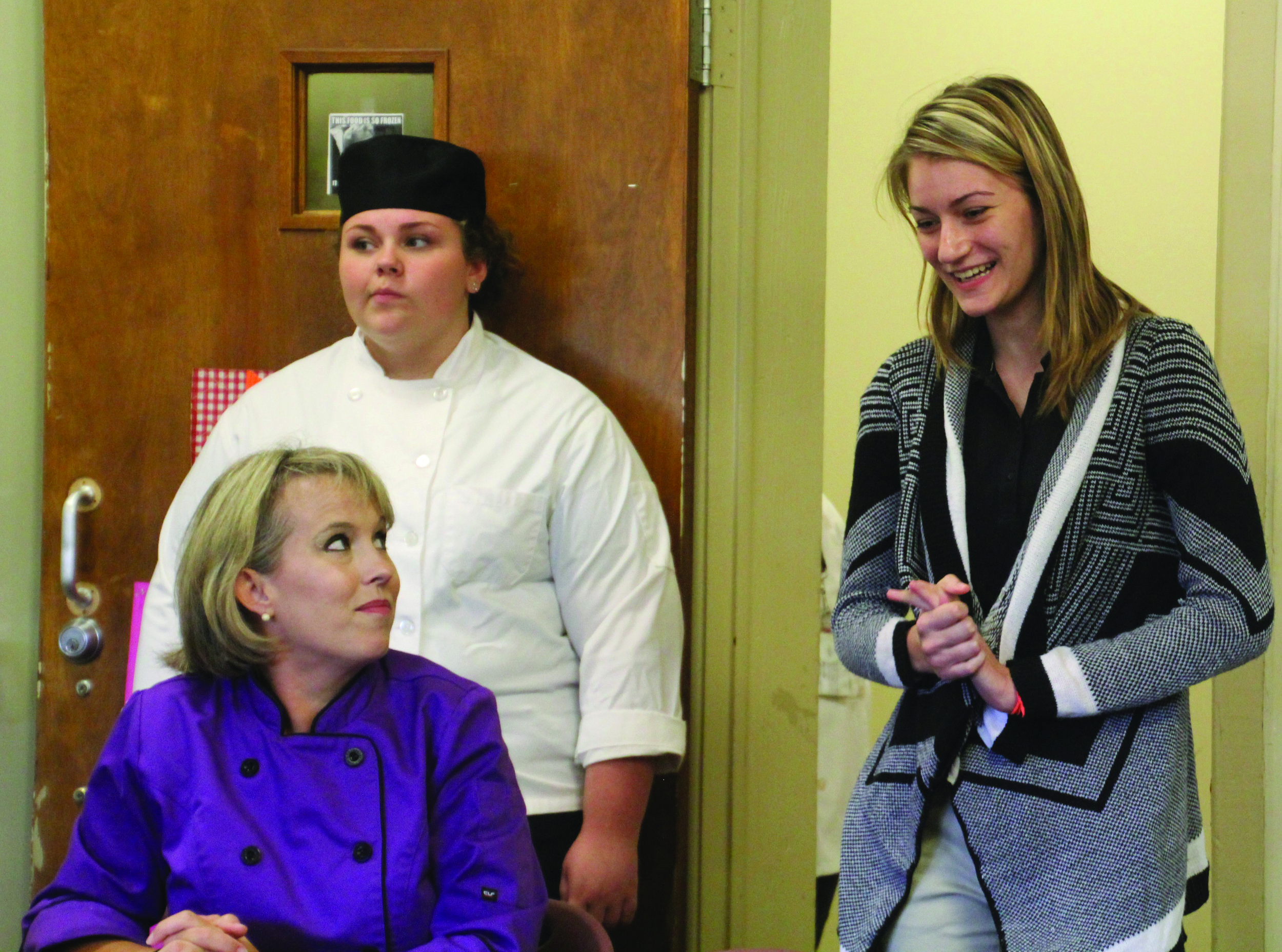 CCCA broadcasting student Emily Pridgen, right, discusses how she and classmate Blair Watts won first place in the nation in a public service announcement contest. Their PSA on bullying, which they wrote and announced, is being broadcast nationwide through the National Association of Broadcasters. Looking on are culinary instructor chef Sherman Axelberg, seated, and Hannah Brown, award-winning commercial baking competitor in state and regional SkillsUSA contests.