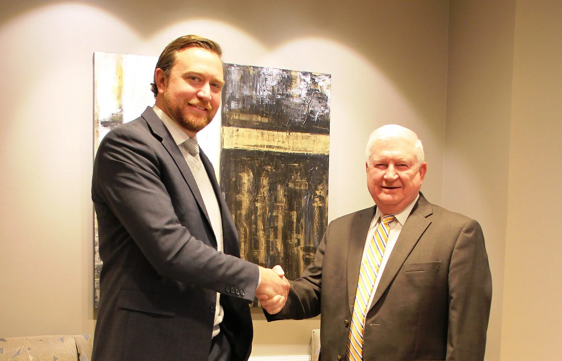 Joshua Winslow, left, has been named to succeed retiring Brunswick Electric Membership Corporation CEO Don Hughes, right.