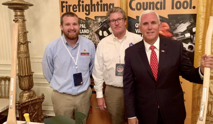 Cameron Council, left, and his father John Council of Council Tool present Vice President Mike Pence with a custom axe Monday during the Made in America Showcase at the White House.
