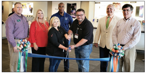 Manager Jason Barnes and Assistant Manager Whitney Hannah cut the ribbon at Victra Verizon Wireless Thursday during a Columbus Chamber of Commerce and Tourism ribbon cutting. Also pictured, from left, are Chamber Chair Jamille Gore, Chamber President Jennifer Holcomb, County Commissioner Jerome McMillian, Whiteville City Manager Darren Currie and Whiteville Mayor Terry Mann.