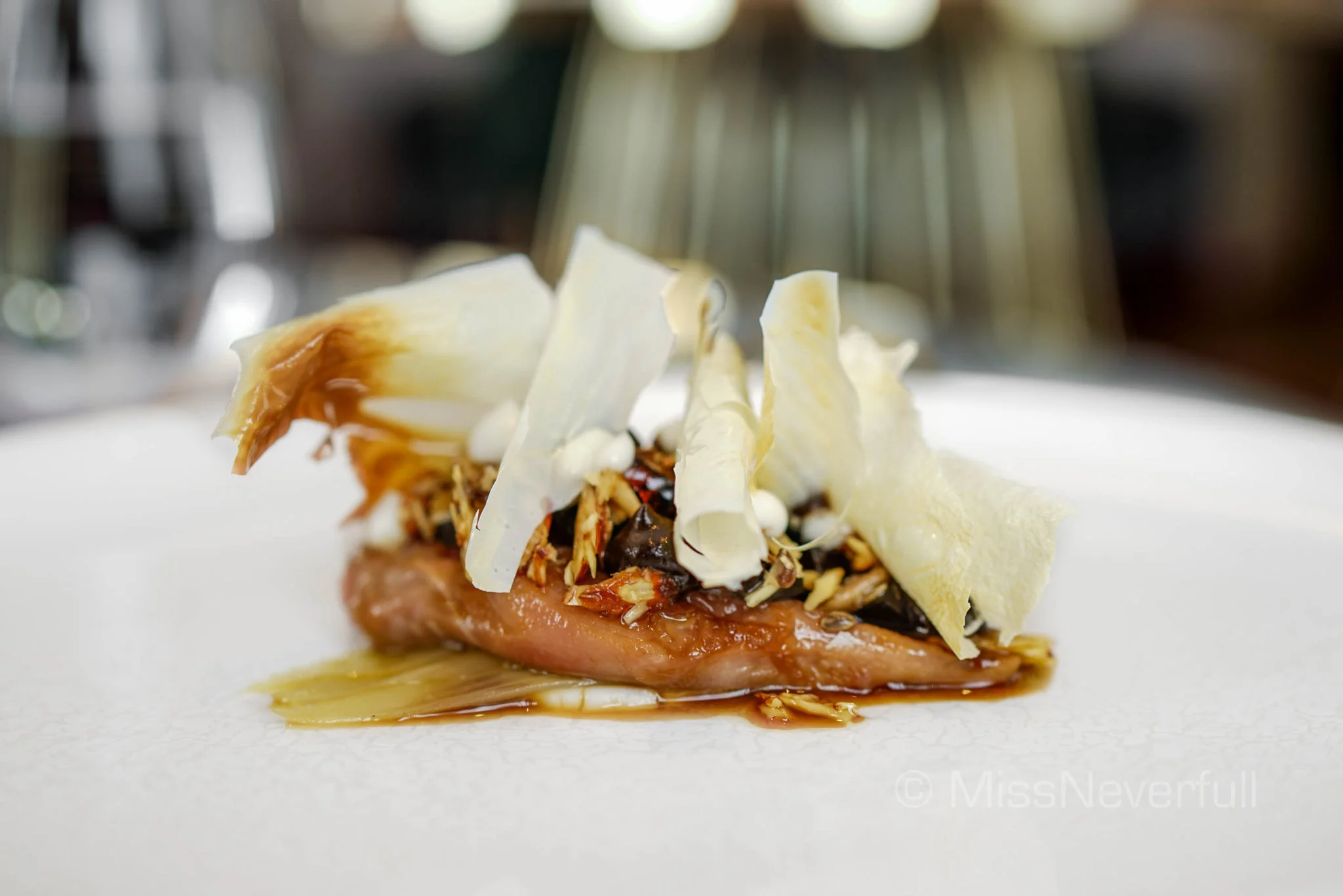 Butter poached quail breast, toasted nuts and seeds, century egg, black garlic, endive heart, roasted milk skin