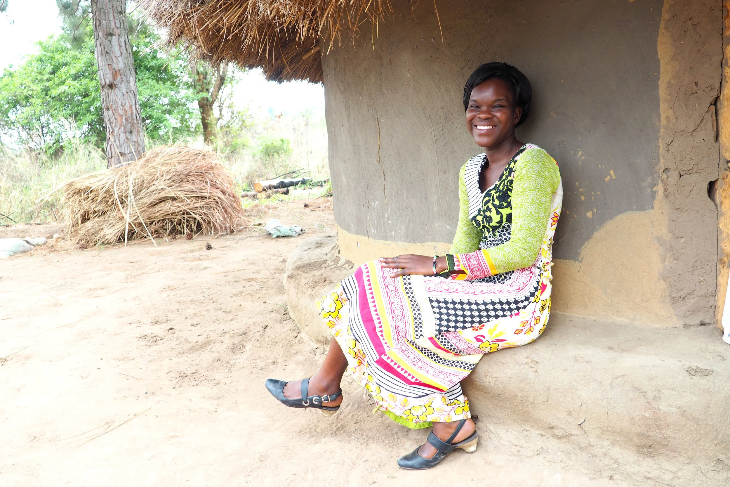 Beatrice in front of her home