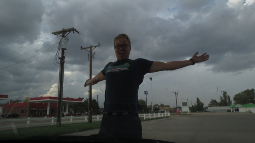 The wind gusts here were up to 50 mph as a storm whipped onto the plains. Moments after this shot, a gust threw sand and rock into the air & he had to take shelter behind the car. His hair was actually filled with pebbles.