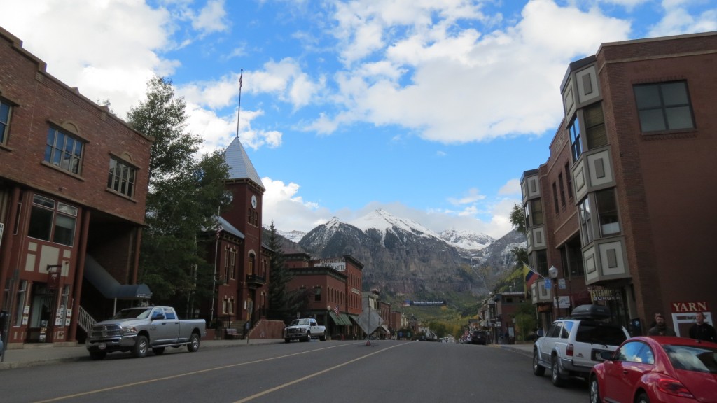 Downtown Telluride with a free stuff wall, lattes at the Steaming Bean, PO boxes only, the occasional wild black bear, a gondola from the street to the mountain and hitching posts for your dog.