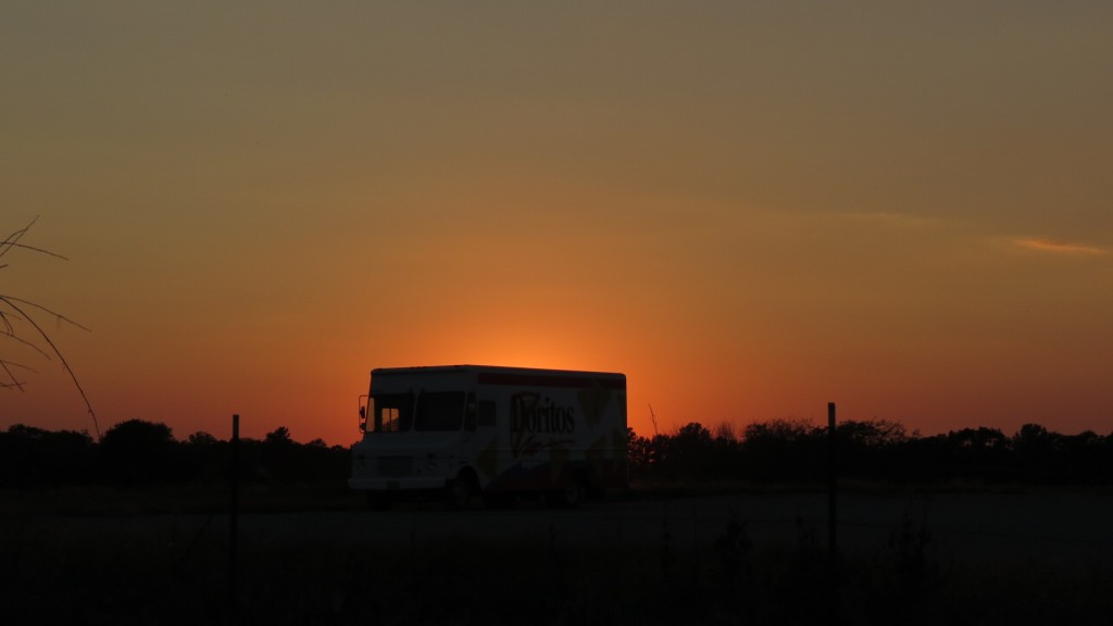 An empty dorito truck faces the swollen peach sunset. “Alone again,” it sighs, and nods to the bleating twilight bugs, waiting for the light to fade to black.