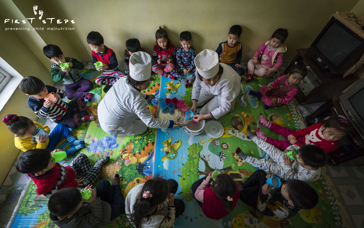 Loving hands serve up soymilk at the Yangji Daycare.