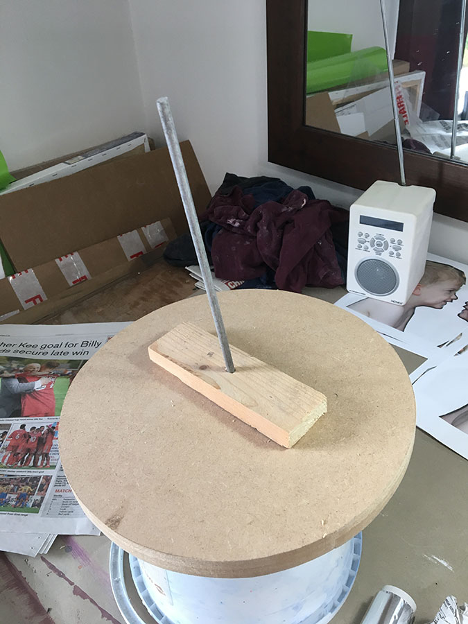 I made a simple armature (the metal rod and rectangular section of timber) to support the weight of the clay. Placing it on a circular wooden base means I can then rotate it easily as I'm working. Note the highly technical upturned tub below to allow for rotation. One of these days I will invest in proper banding wheel.