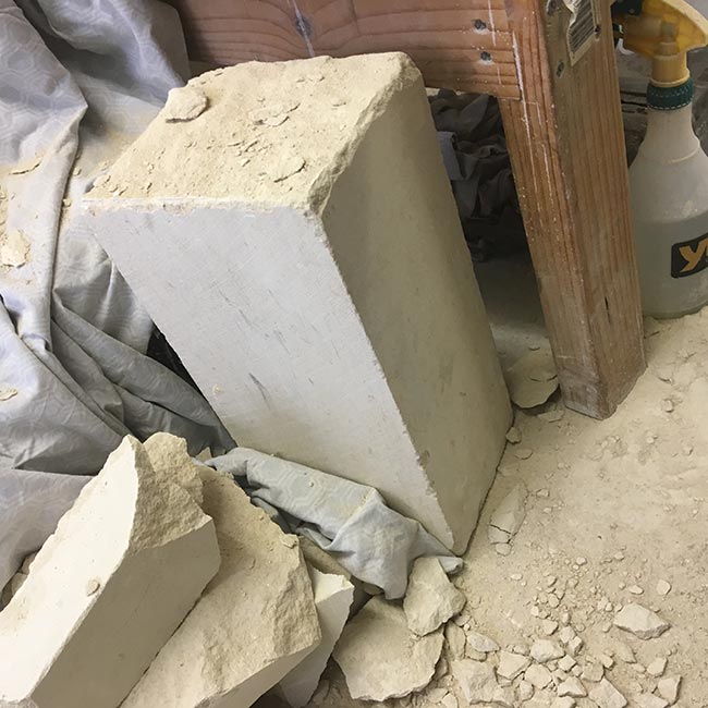I had a tall block of Portland Stone in my studio that first (much like myself) needed cutting down to size. This involves scoring along each face with a chisel so that in theory, with some strategic blows, the block splits along the lines. For some unfathomable reason this is a photo of the remaining section, rather than the larger block I was using.