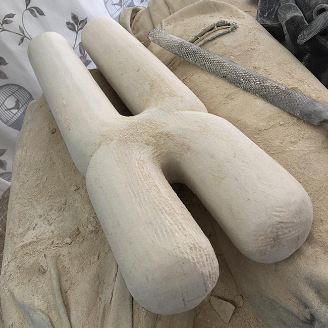 The whole piece is refined with chisels, then rasps (the file shown here) and finally the arduous task of sanding through various grits of sanding blocks until a smooth finish is reached.