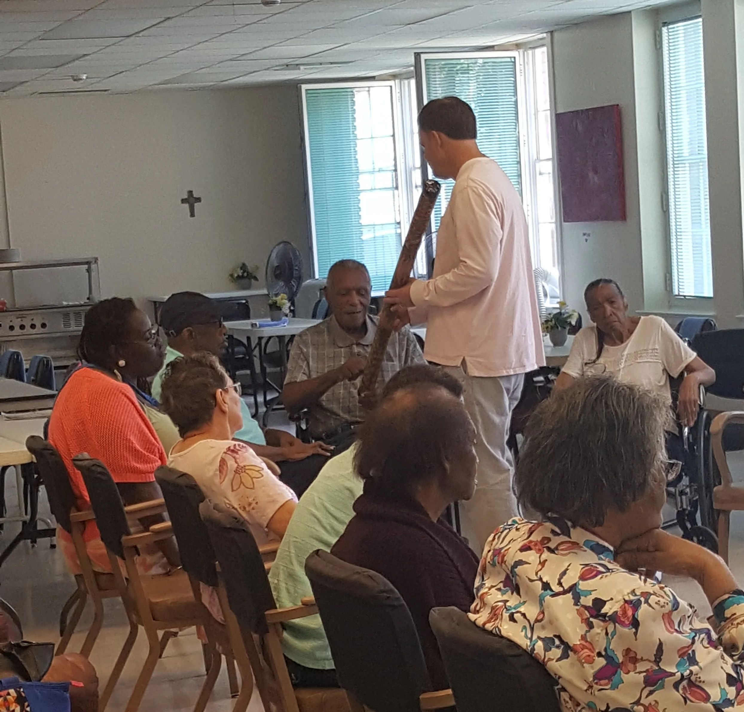 Walker Wright, our drum therapist, showing clients how to play the rainmaker.