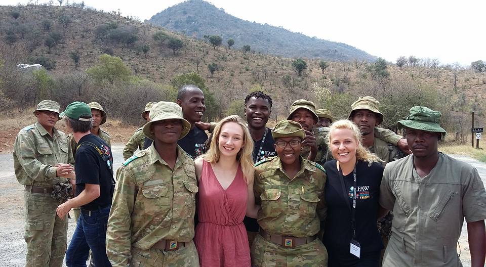 Olivia Taylor and Josephine Crouch stand next to the legendary Reginah Mogwera. A game warden and rhino anti-poaching hero.