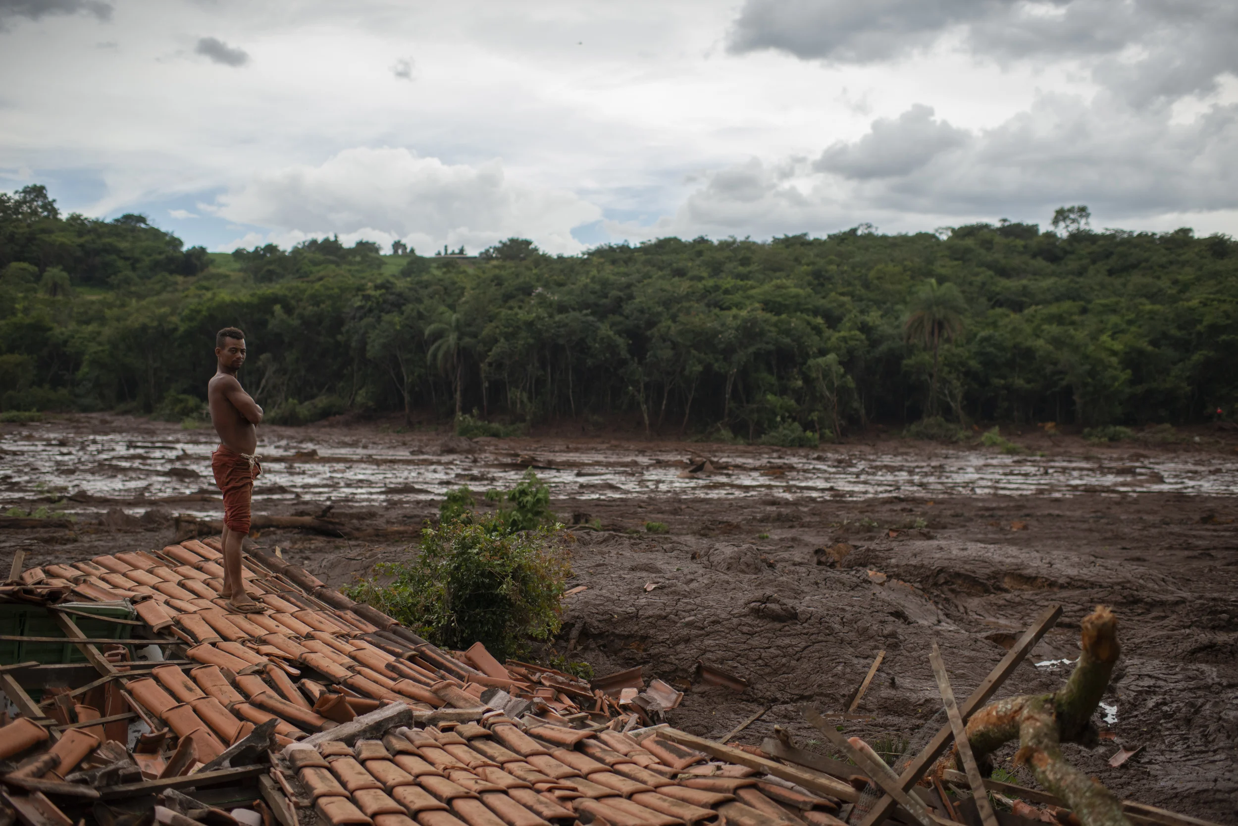  Emerson dos Santos stands on the debris of her mother's house in Brumadinho, Jan. 26. Dos Santos' mother was not in the house and survived the tragedy. 2019 © FOR BBC NEWS BRASIL 