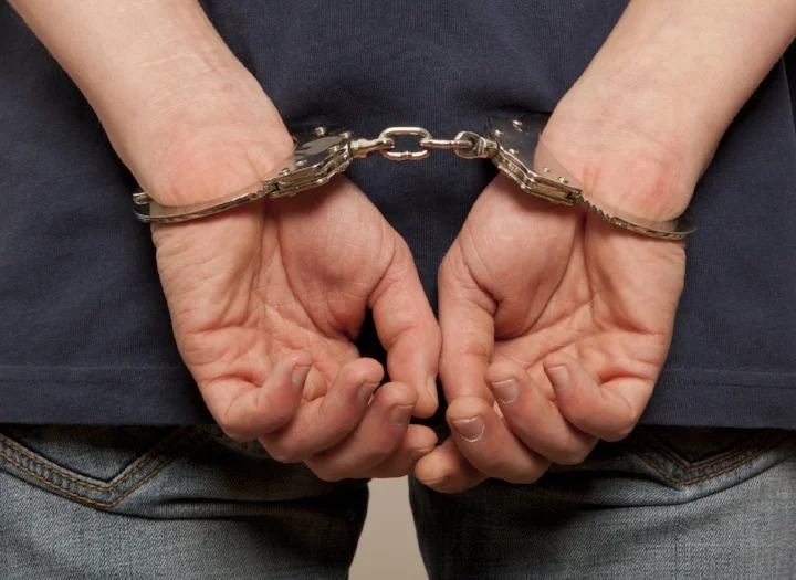 bigstock-Close-up-Arrested-man-handcuf-79929682.jpg