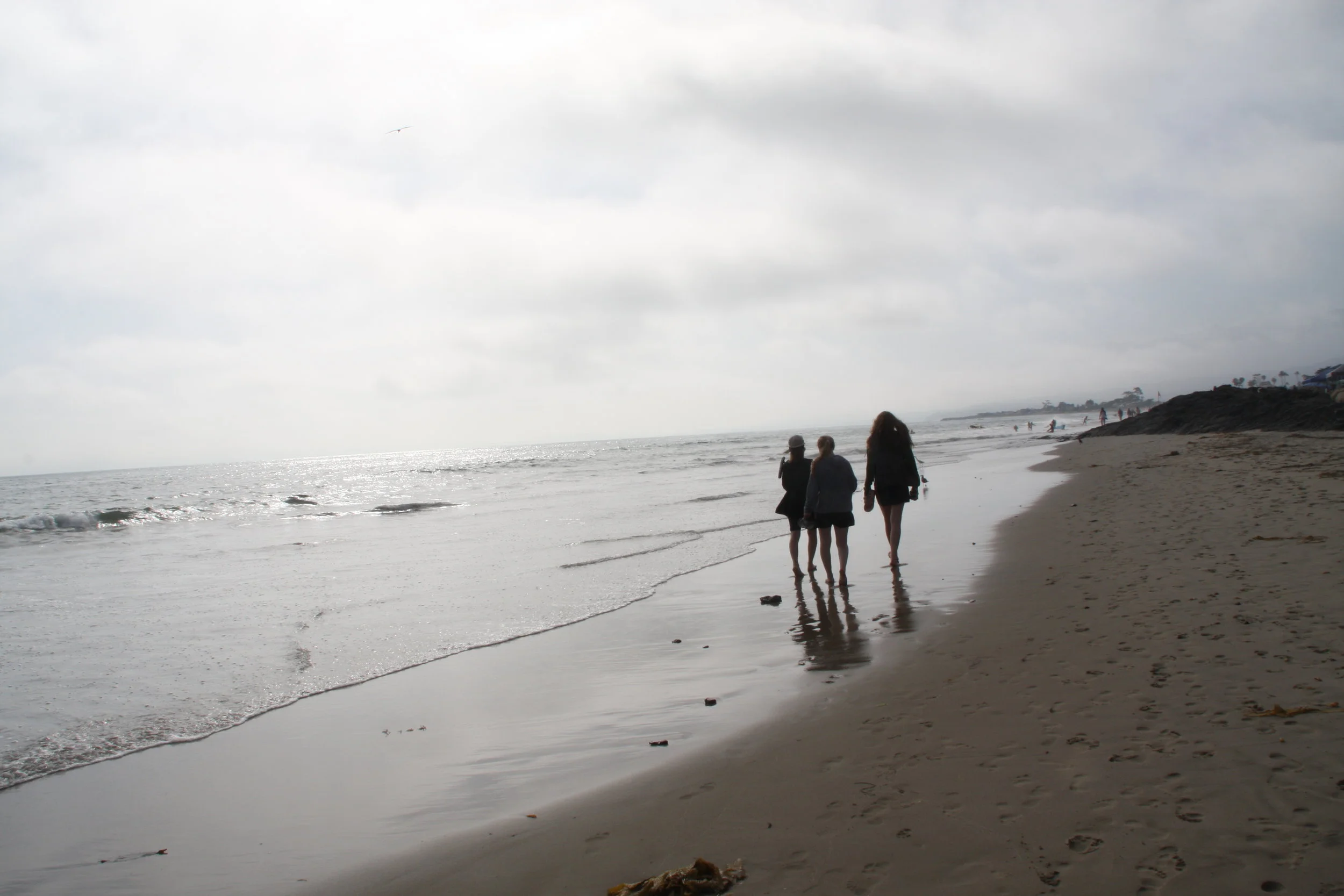 The best time of day to walk on the beach is when the sun is going down.