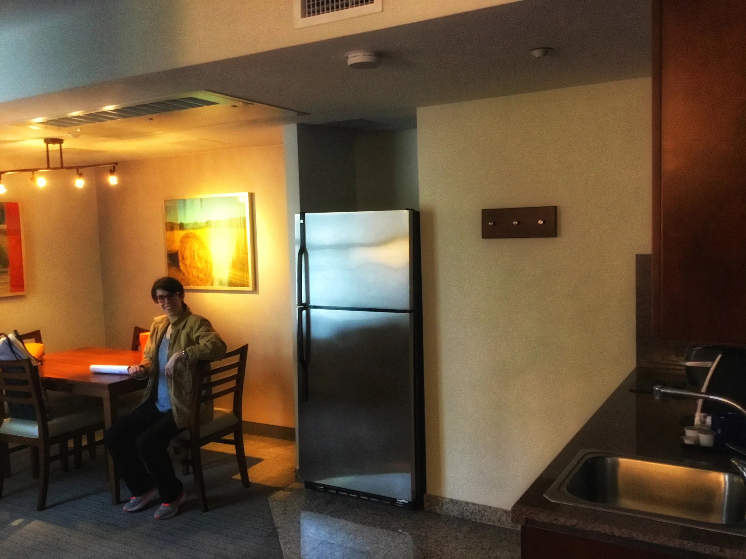 My daughter in the full kitchenette + dining area