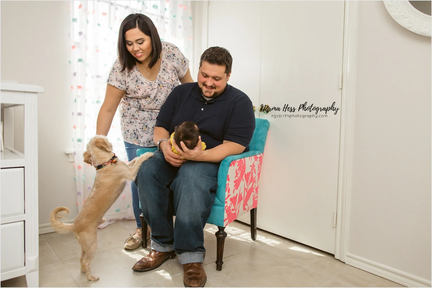 Odie comes in for a closer look during this intimate newborn session at home. | Photo by Norma Hess at SojourningBirth.com
