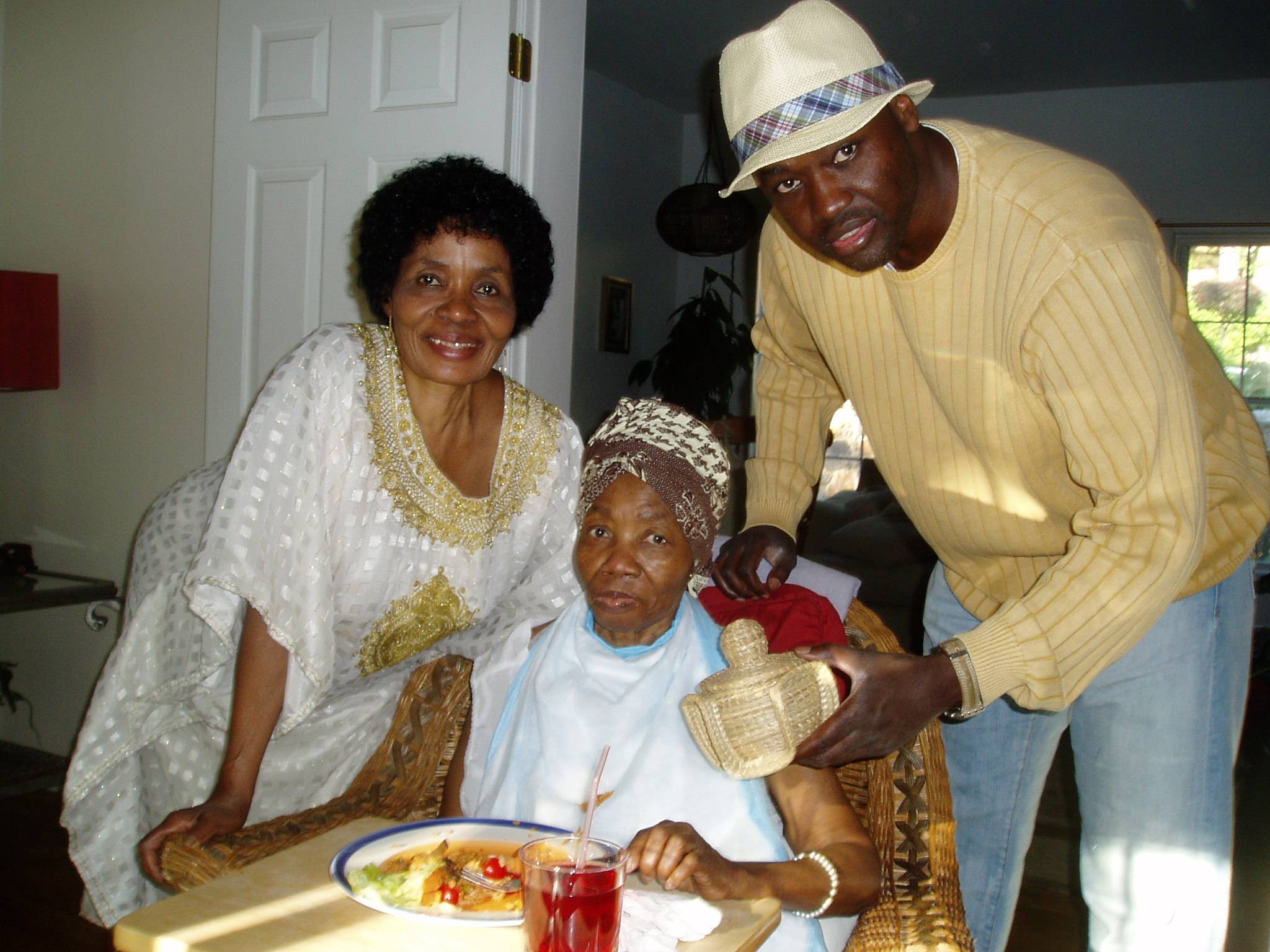   On July 4, 2009, I give my aunt, Phoebe, a birthday gift as her sister -- my mom -- smiles approvingly. The get-together occurs at North White Plains, New York, where Auntie Phoebe lives with her daughter, Dr. Kafui Demasio.  