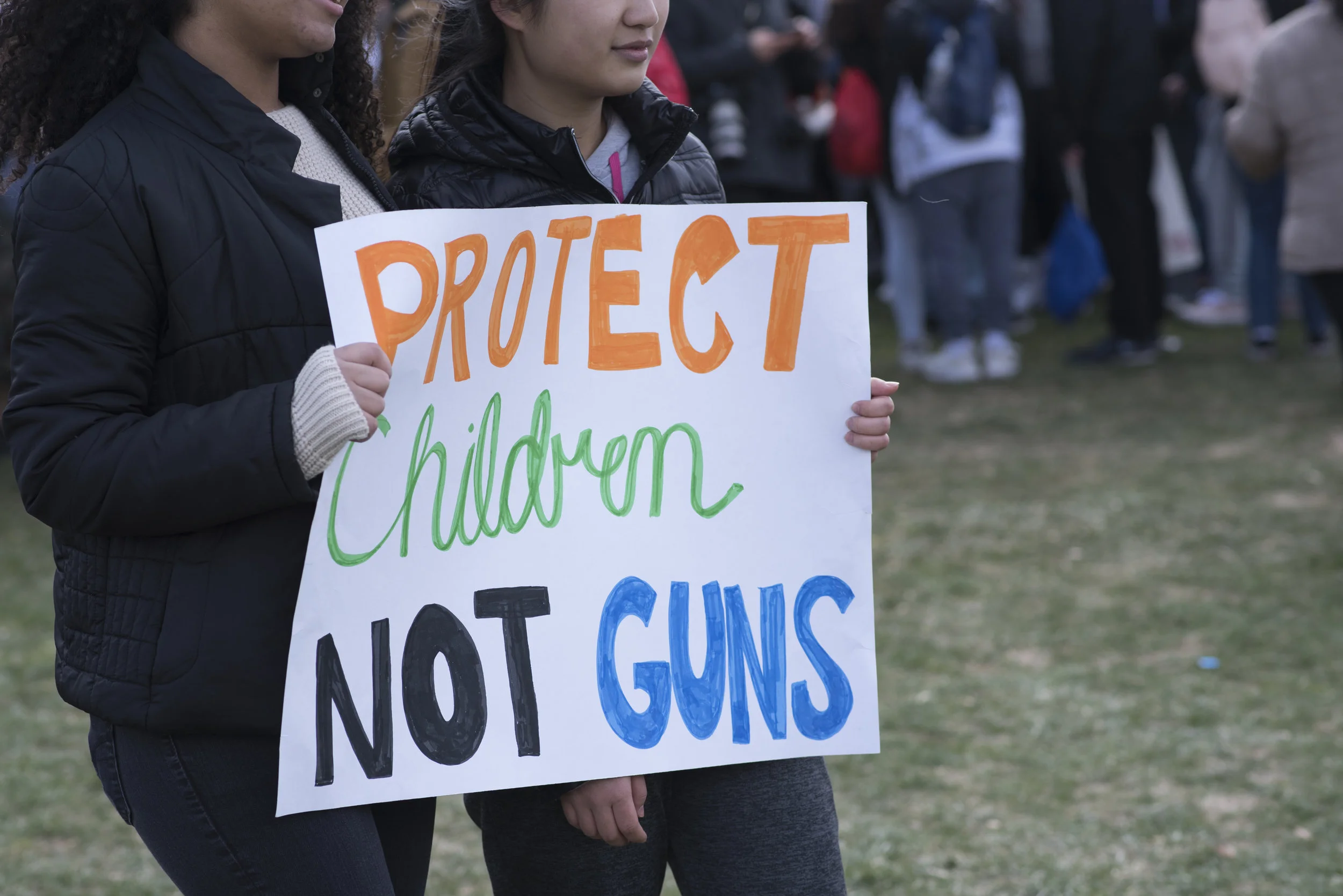 Student Walkout, Washington, DC: March 14, 2018. Two students holding sign, "Protect children, not guns."