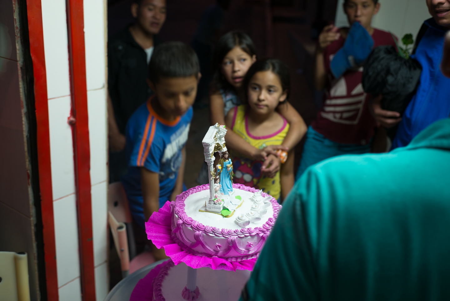  Children viewing a first communion cake, Llanditas, Medellín, Colombia. 