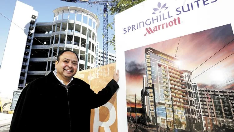 Vinay Patel, CEO of SREE Hotels, stands in front of the construction site for the new Springhill Suites Marriott that is adjacent to the uptown area. 