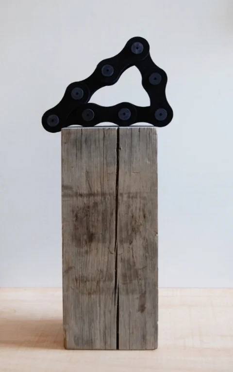    Triangle Black Chain,&nbsp;   2012 |&nbsp;Felt, wooden spools and recycled wood beam |&nbsp;Dimensions variable  &nbsp;&nbsp;  