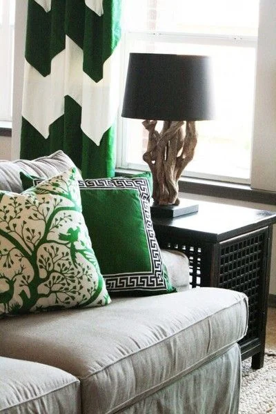 Playful and classic patterns in the same shade of emerald are elegant against the neutral backdrop of this room.