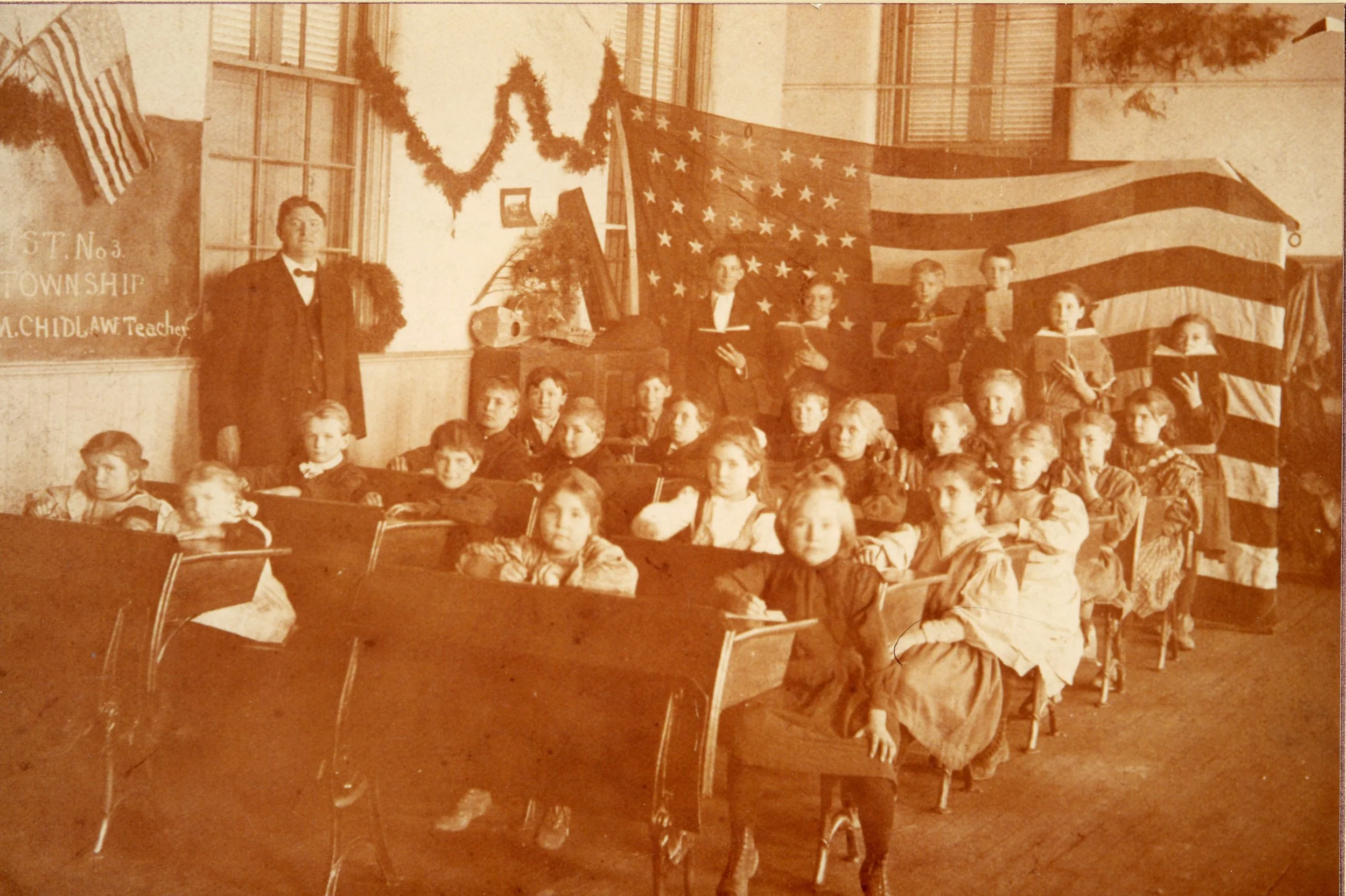 Myers Schoolhouse classroom with teacher, William Chidlaw in the early 1900s. All rights reserved: Delhi Historical Society.