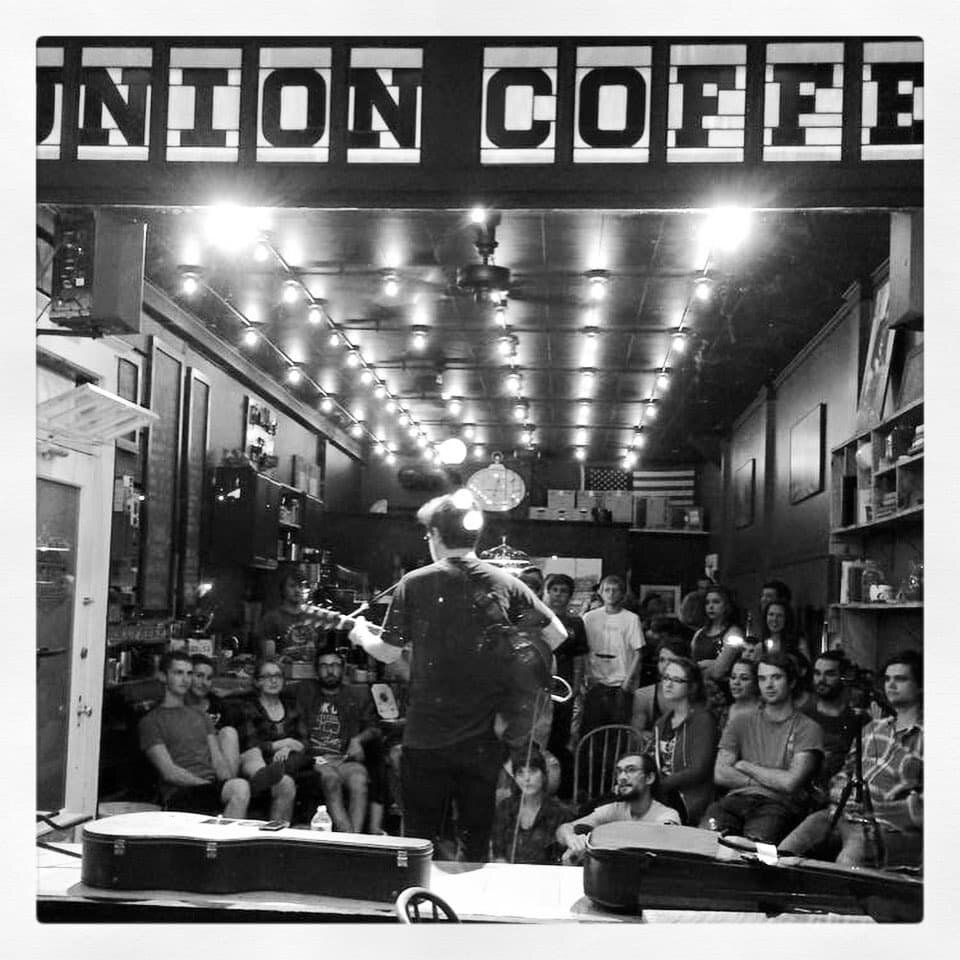 A crowd gathers to hear live music in the first days of Union Coffee Co.