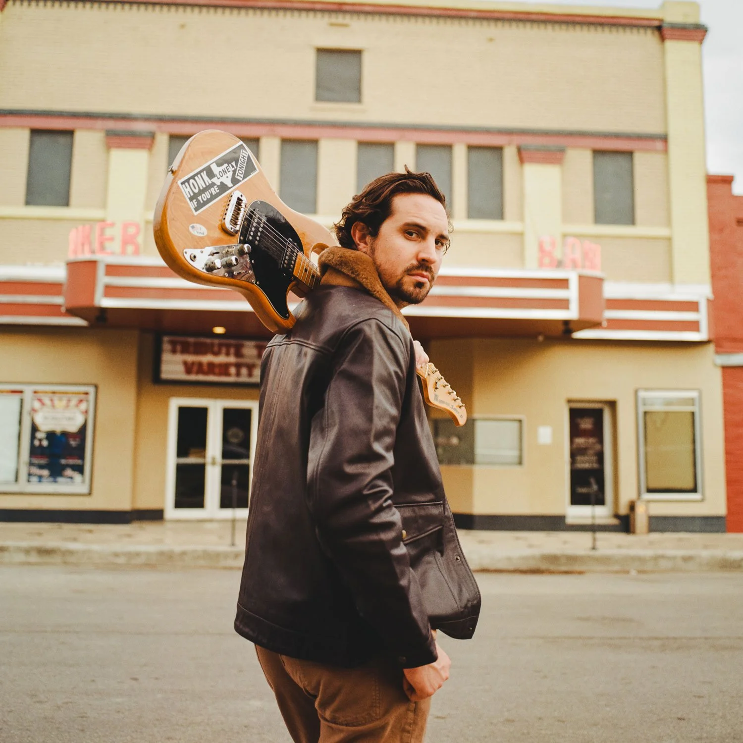 Danny Golden with an electric guitar over his shoulder