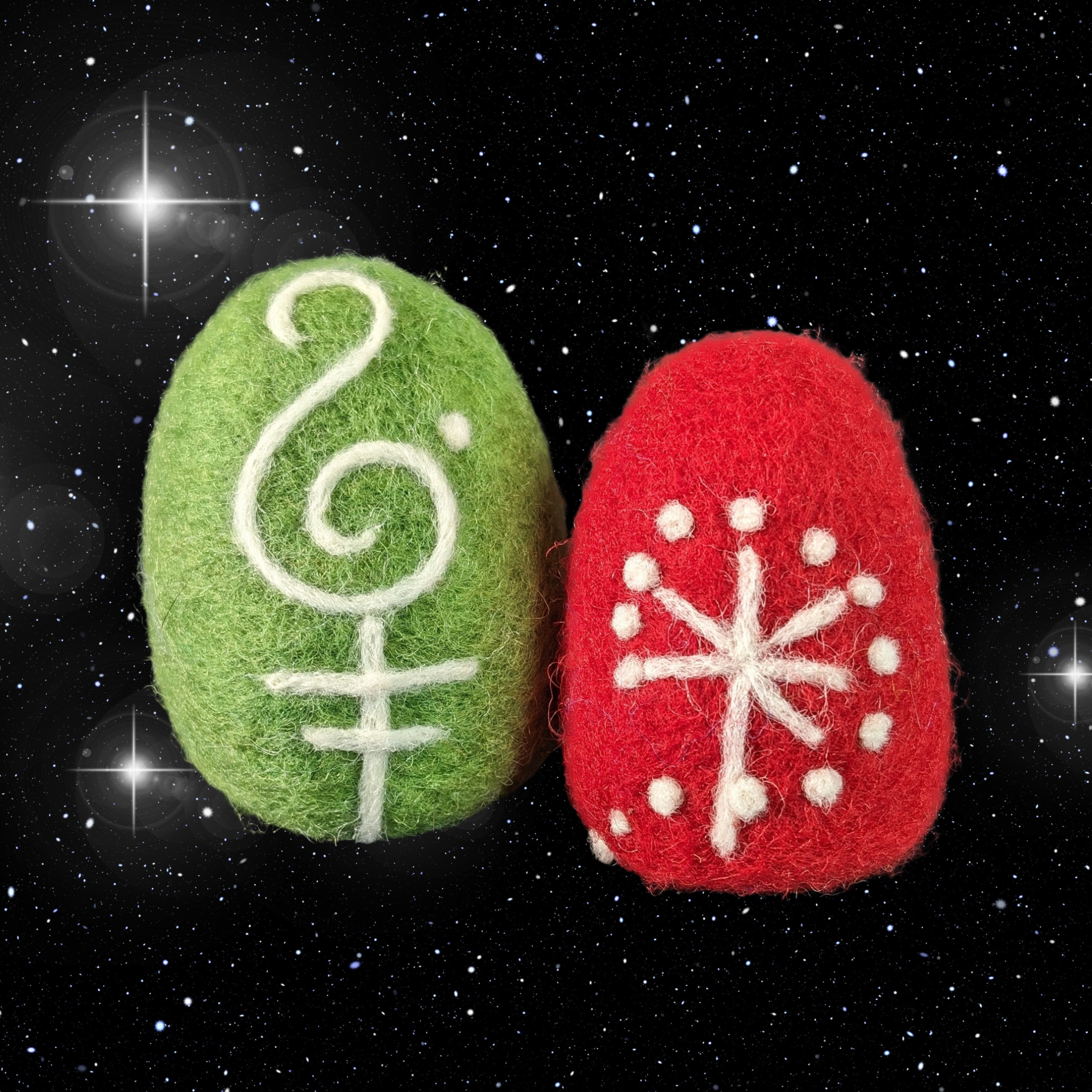 two needle felted eggs with designs
