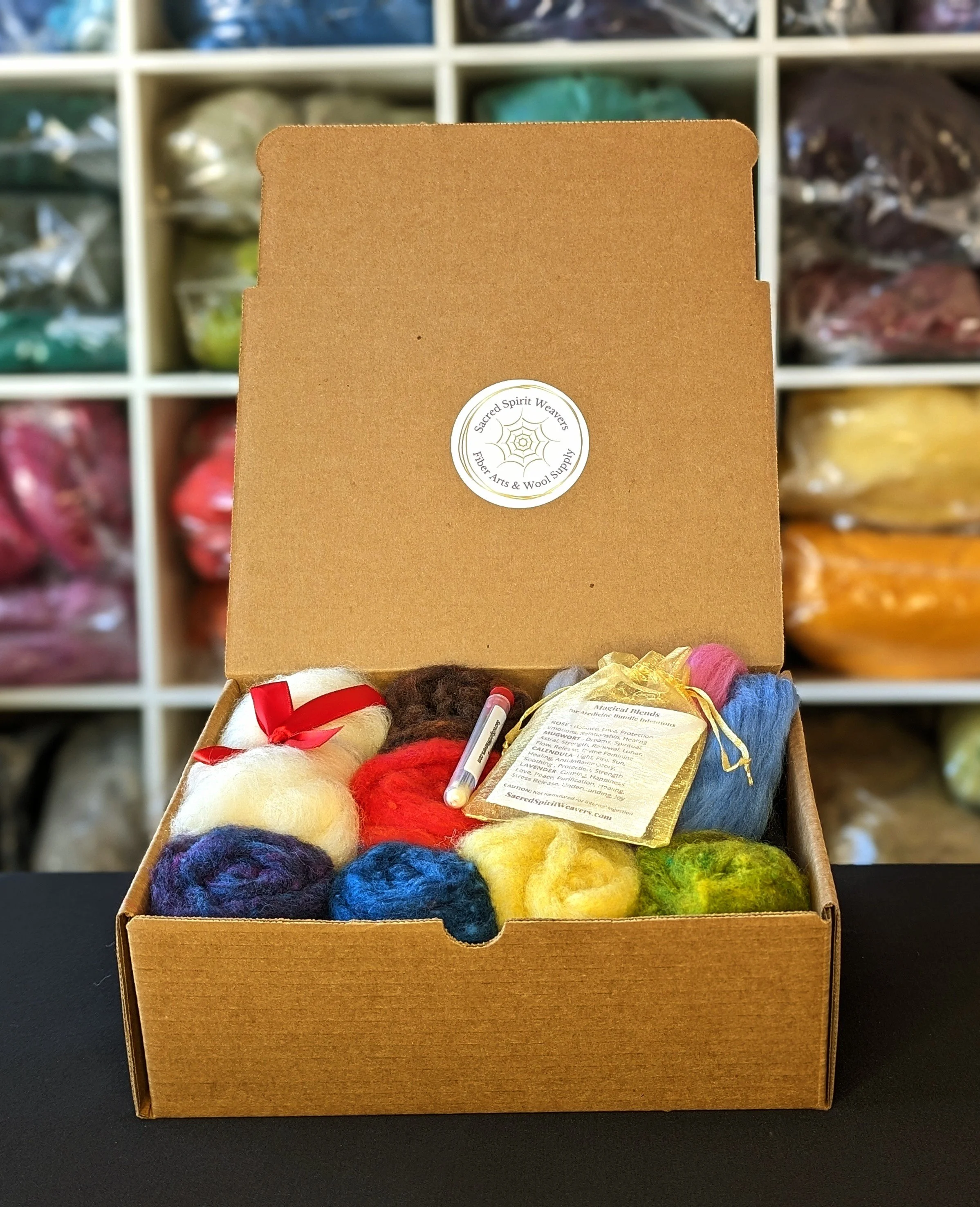A needle felting kit box of assorted wool colors and materials.