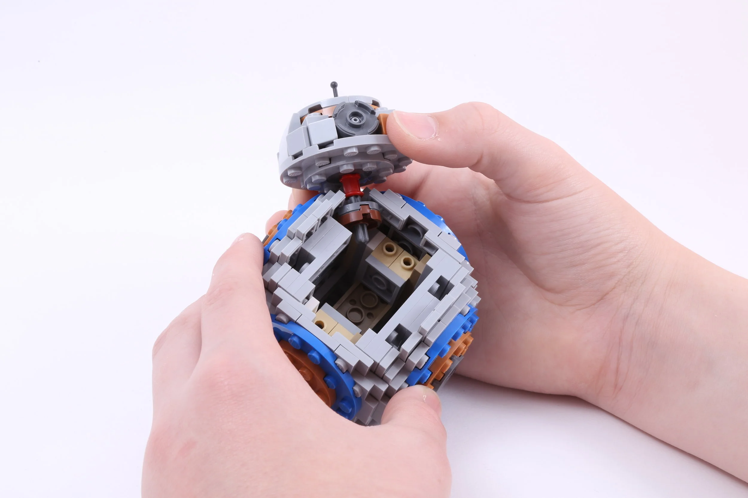  Hold the body with the open corner at the top. Place the axle on the head assembly in the open corner. The pieces should be spaced so that the round plates are in the body and the bushing is right at the gap. You can snug the pieces up to make it a 